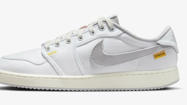 Side view of a white and grey Air Jordan sneaker.
